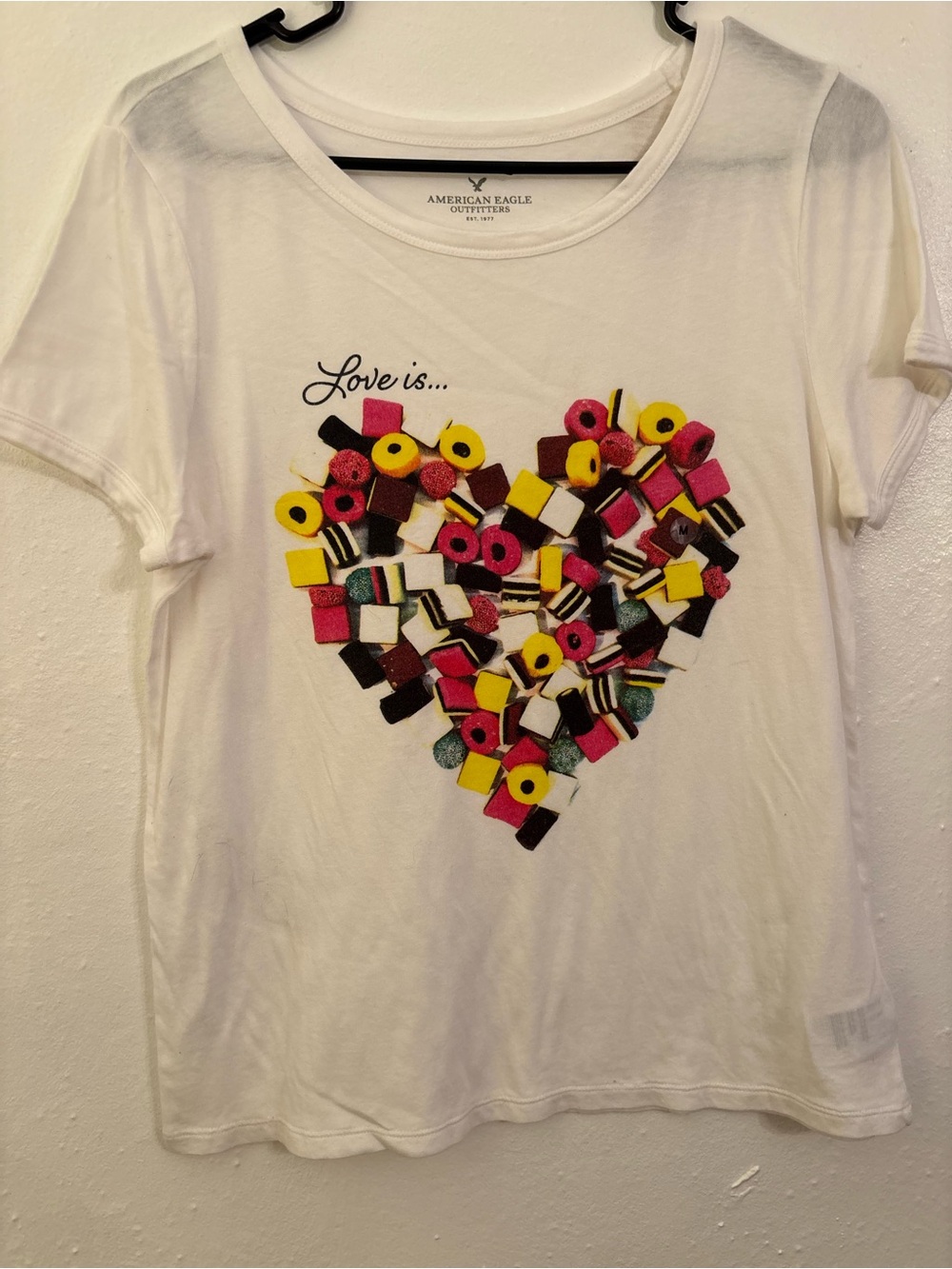 American Eagle women’s ' White 'Love Is' Candy Heart Graphic Tee